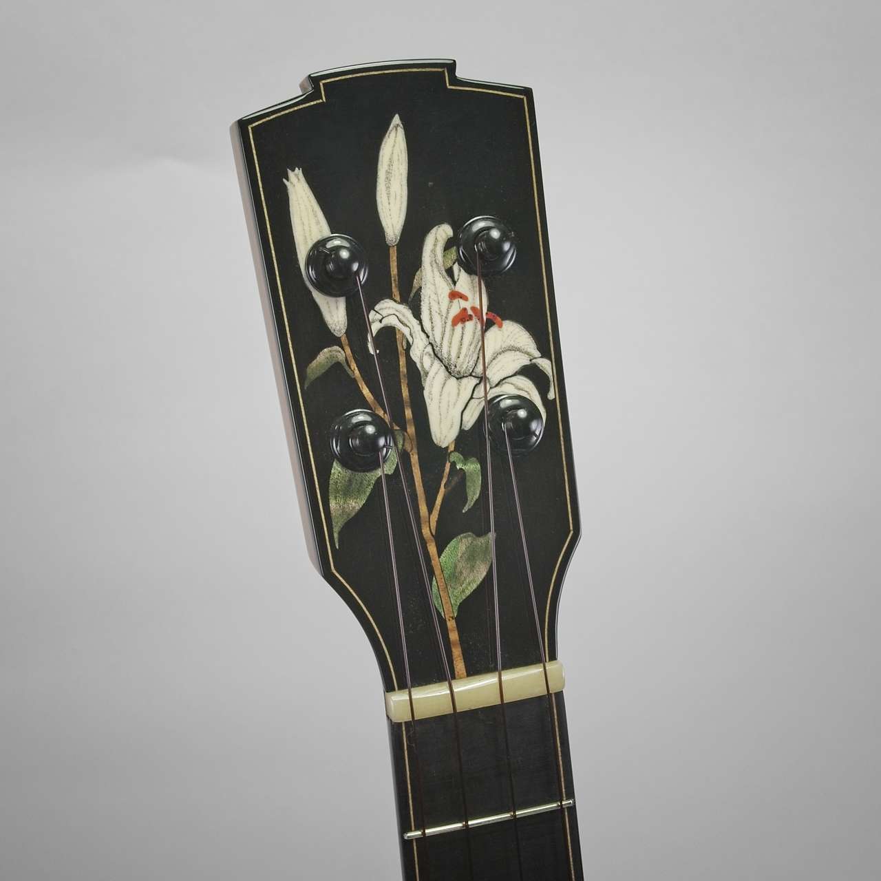 Mastergrade Australian Blackwood concert ukulele with Yellow Cedar soundboard. Lily inlay with scrimshaw shading to peg head.